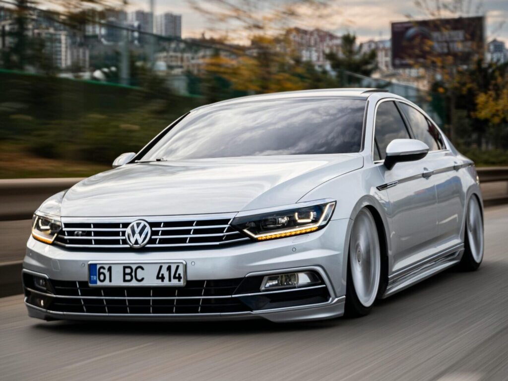 A silver Volkswagen Passat, customized and in motion, speeds through urban Turkey scenery.
