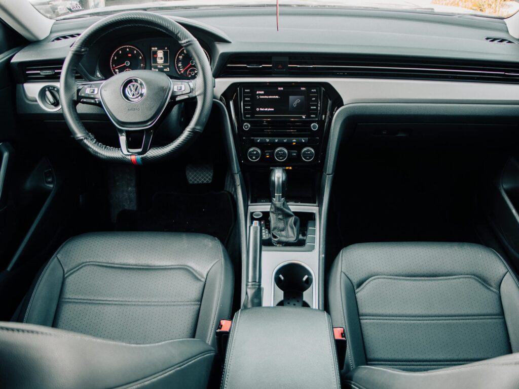 Explore the sleek and modern interior of a Volkswagen with a focus on the dashboard and steering wheel.